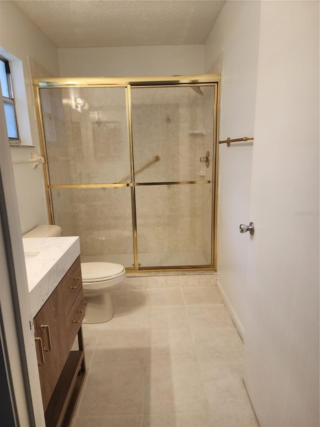 bathroom featuring vanity, a textured ceiling, toilet, and an enclosed shower