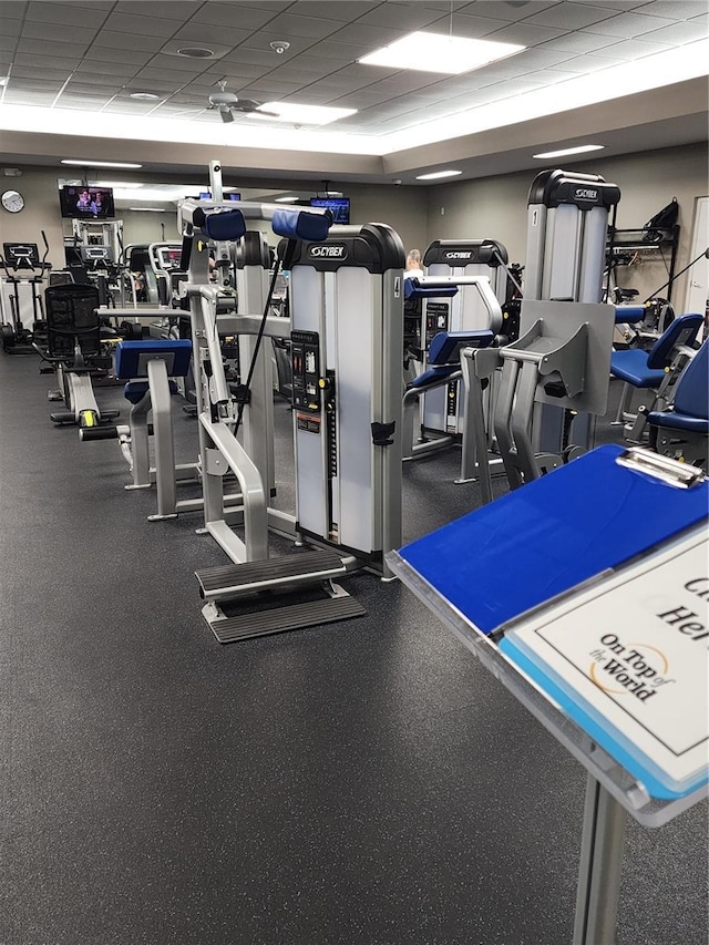 gym with a paneled ceiling