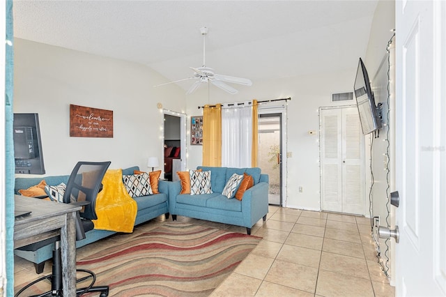 tiled living room featuring ceiling fan and lofted ceiling