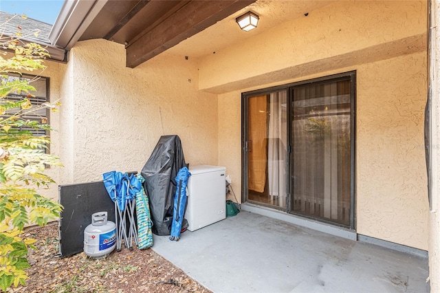 doorway to property with a patio