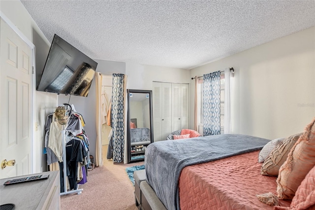 carpeted bedroom featuring a textured ceiling