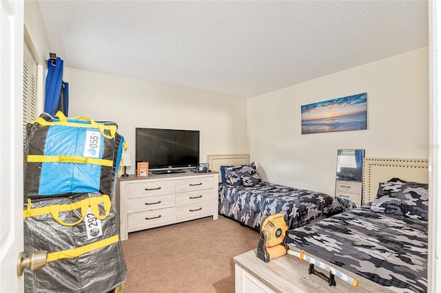 carpeted bedroom featuring a textured ceiling