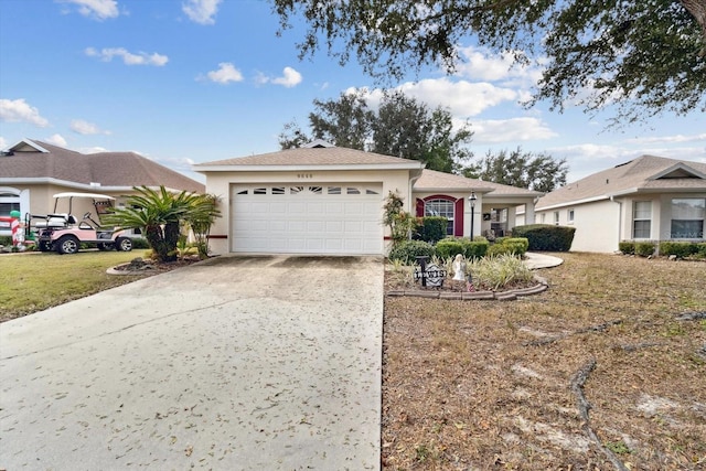 ranch-style house featuring a garage and a front yard