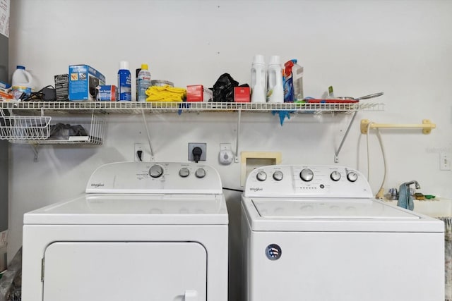 clothes washing area with washing machine and clothes dryer