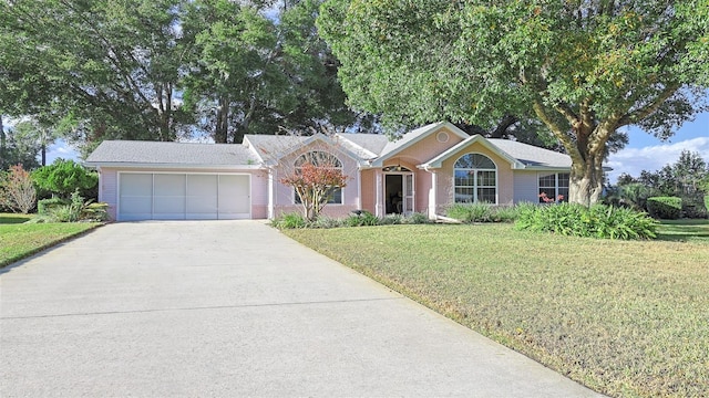 single story home featuring a front yard and a garage