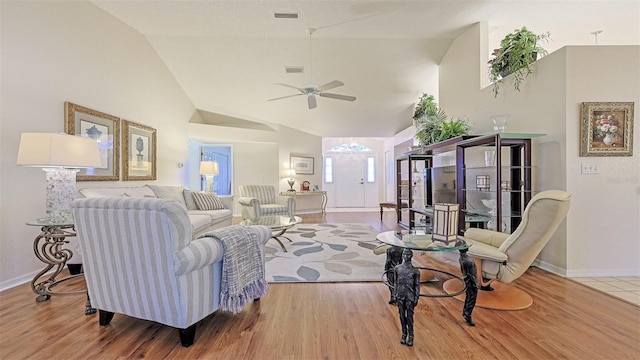 living room featuring wood-type flooring, vaulted ceiling, and ceiling fan