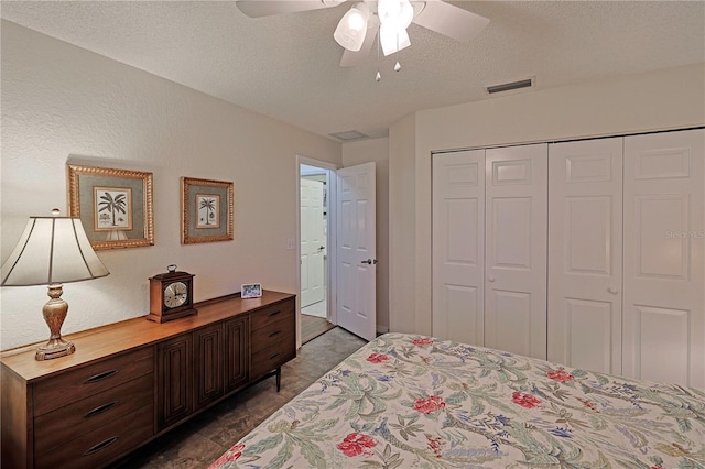 bedroom with a textured ceiling, a closet, and ceiling fan