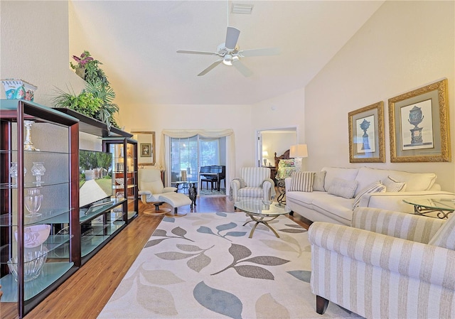 living room with ceiling fan and light hardwood / wood-style flooring