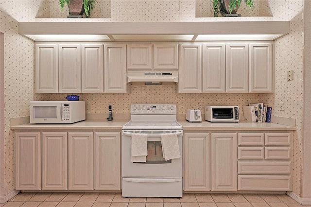 kitchen featuring electric range and light tile patterned flooring