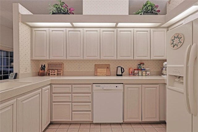 kitchen featuring a textured ceiling, white appliances, and light tile patterned flooring