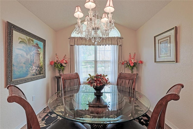 dining room featuring a chandelier and lofted ceiling