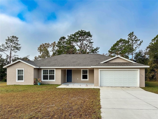 single story home with a garage and a front lawn