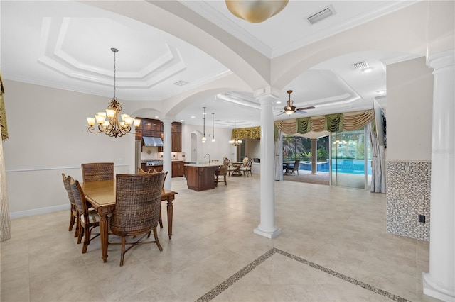 dining area featuring a tray ceiling, crown molding, and ceiling fan with notable chandelier