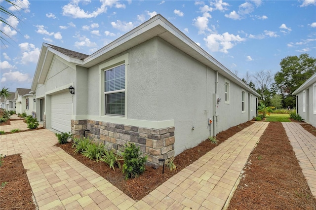 view of side of property with a garage