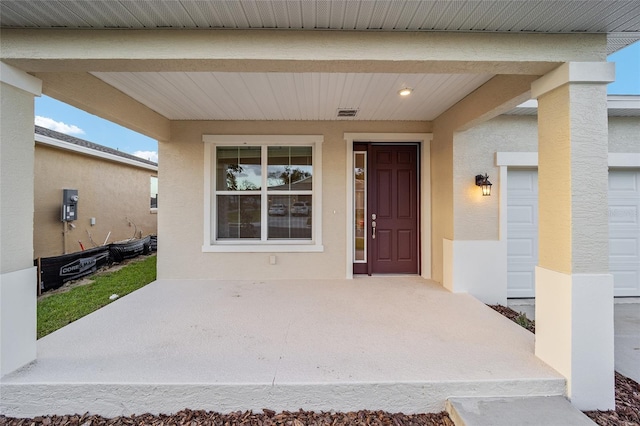 view of exterior entry featuring a porch