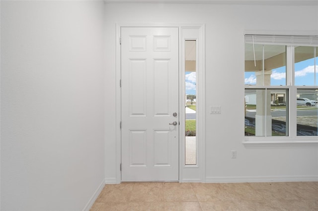 entryway with light tile patterned floors