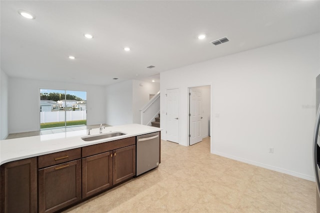 kitchen featuring dishwasher, dark brown cabinetry, light stone countertops, and sink