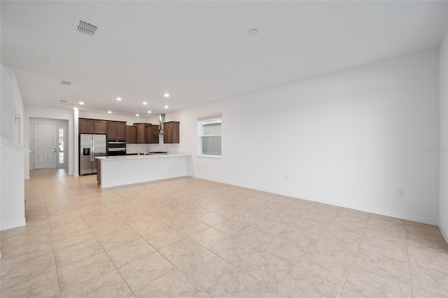 unfurnished living room featuring light tile patterned floors