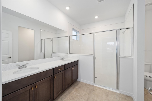 bathroom featuring an enclosed shower, vanity, and toilet