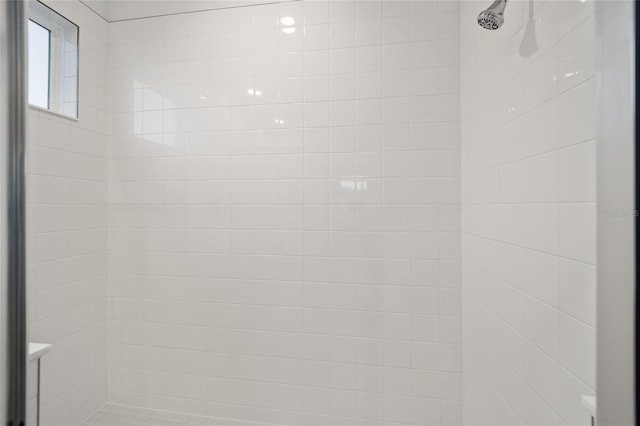 interior details with a tile shower