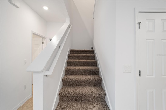 stairs featuring carpet flooring