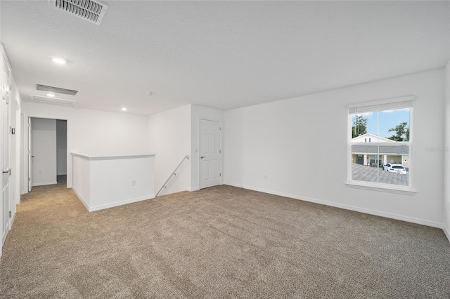 spare room featuring light colored carpet