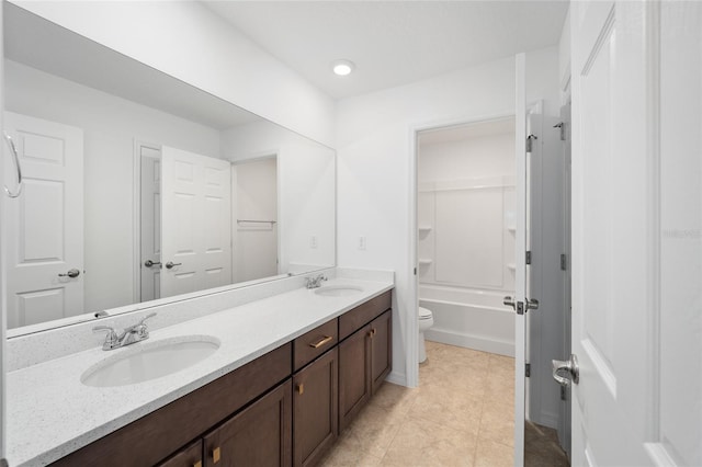 bathroom featuring tile patterned flooring, vanity, and toilet