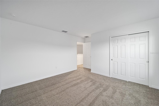 unfurnished bedroom featuring a closet and carpet