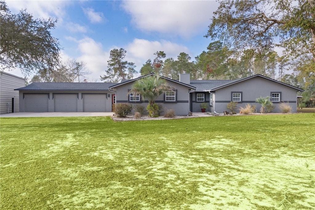 ranch-style home with a garage and a front lawn