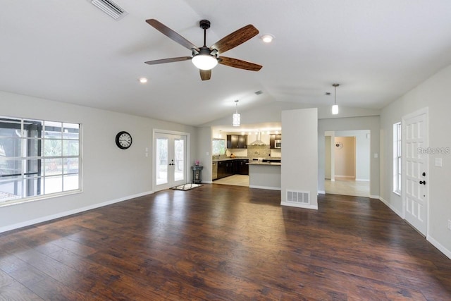 unfurnished living room with ceiling fan, french doors, dark wood-type flooring, and vaulted ceiling