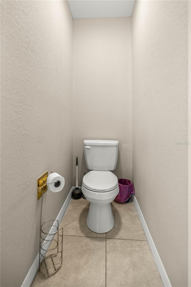 bathroom with tile patterned flooring and toilet