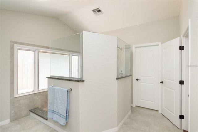 bathroom with lofted ceiling and walk in shower