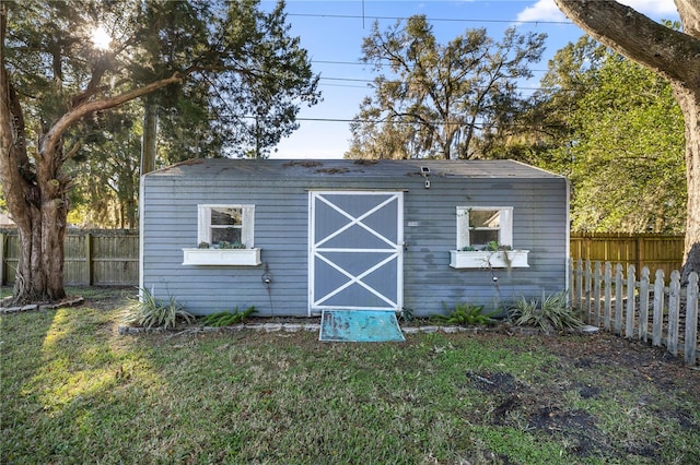 view of outbuilding with a lawn