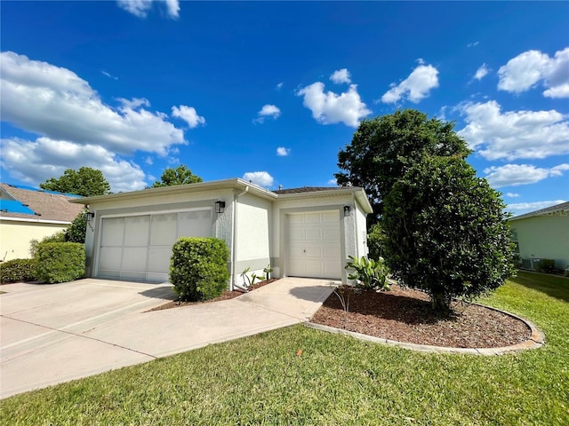 view of front of home featuring a front yard and a garage