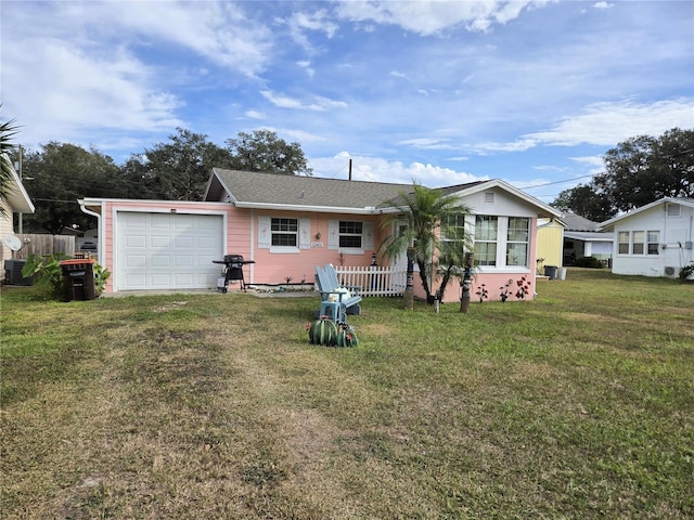 back of house with a yard and a garage