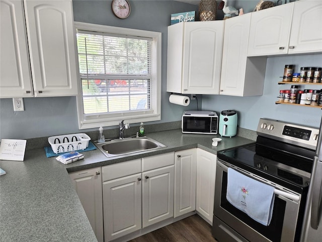 kitchen with white cabinetry, sink, dark wood-type flooring, and stainless steel electric range