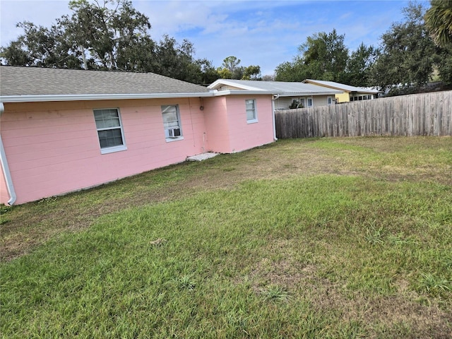 rear view of property featuring a yard