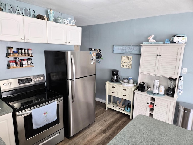 kitchen featuring dark hardwood / wood-style flooring, white cabinetry, and stainless steel appliances