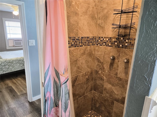 bathroom with a shower with shower curtain and hardwood / wood-style floors