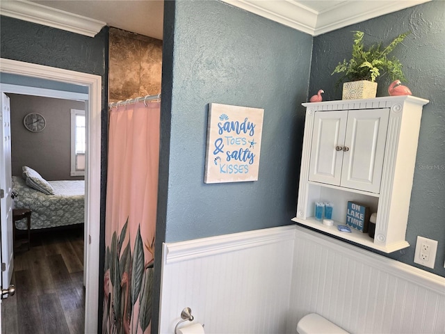 bathroom featuring hardwood / wood-style floors, walk in shower, and ornamental molding