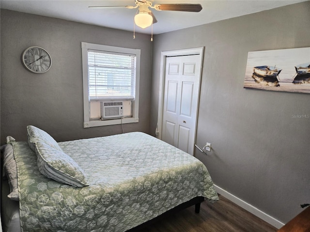 bedroom with ceiling fan, a closet, cooling unit, and dark wood-type flooring