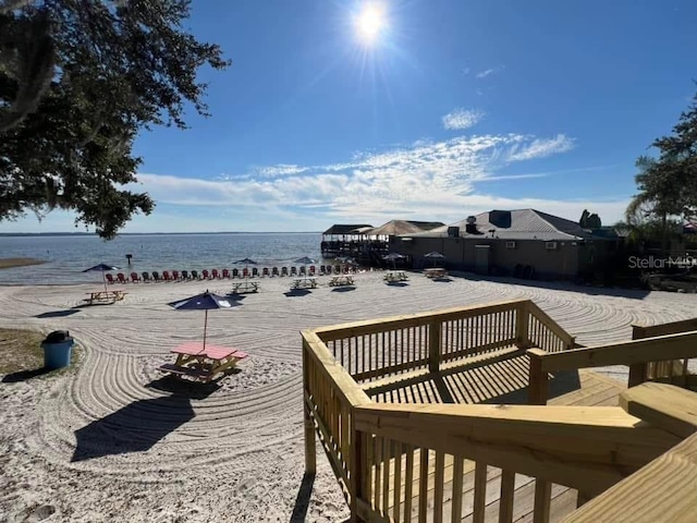 exterior space featuring a beach view and a water view