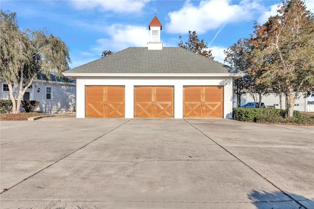 exterior space with a garage and an outdoor structure