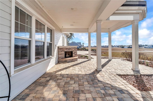 view of patio / terrace with an outdoor stone fireplace