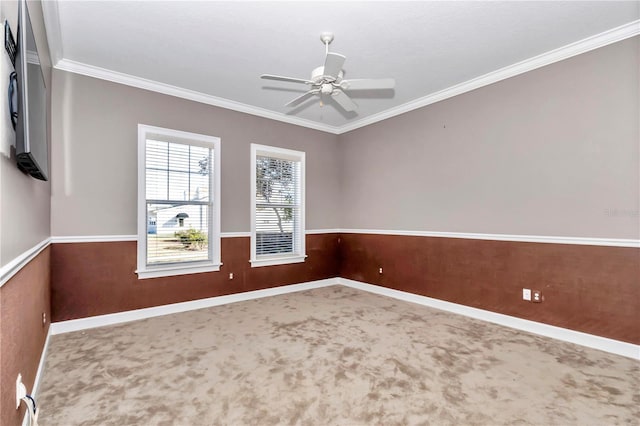 carpeted empty room featuring ceiling fan and ornamental molding