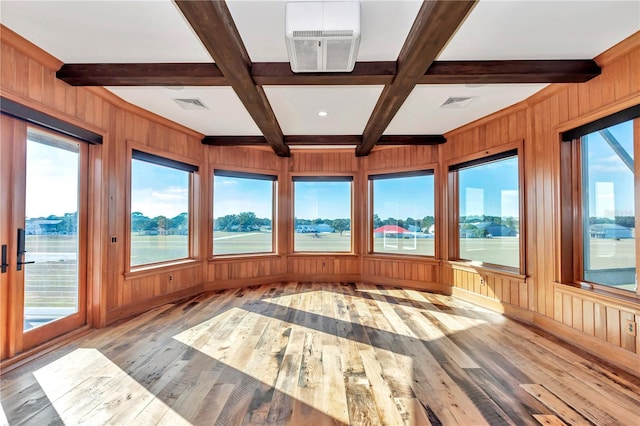 unfurnished sunroom with coffered ceiling, beam ceiling, and plenty of natural light