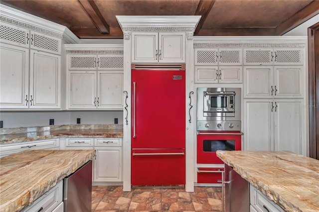 kitchen with stainless steel microwave, white cabinets, refrigerator, and oven