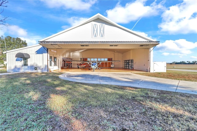 back of property featuring a lawn