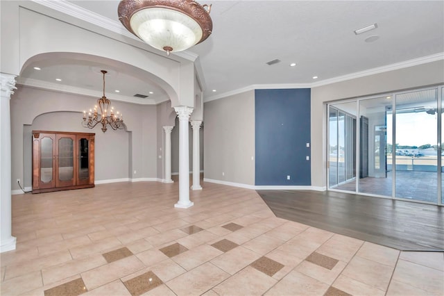 interior space featuring light tile patterned floors, an inviting chandelier, ornamental molding, and decorative columns