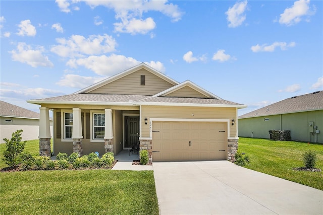 view of front of home featuring covered porch, a garage, and a front yard